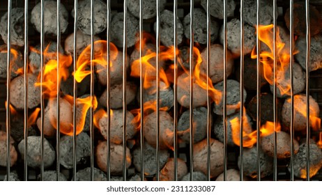 Top Shot of Grill Grate with Briquettes and Fire Flames