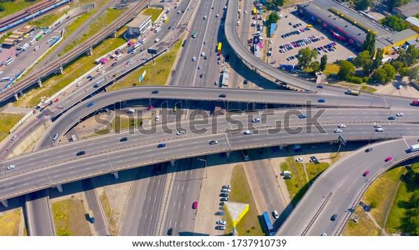 top shot of a modern industrial\
motor vehicle interchange with overpasses and bridges. part on\
reconstruction with speed limits to a minimum. aerial view\
