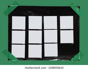 top shot photo of black and white hand copy contact sheet with 11 empty film frames fixed by green sticker tape on green paper background. cool retro picture placeholder.