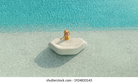 Top Shot Of The Swimming Pool With Lady Sitting On Sofa In The Middle