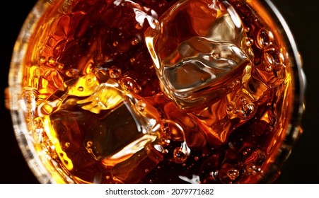 Top Shot Of Whisky Glass With Ice Cubes, Closeup. Isolated On Black Background.