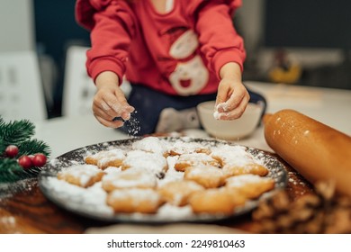 Top and side view of mother and daughter preparing gingerbread cookies with rolling pin in their kitchen in different shapes heart and stars  - Powered by Shutterstock