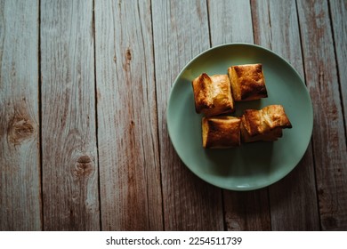Top and side view of puffed pastry and cheese or Greek yogurt on wooden background  - Shutterstock ID 2254511739