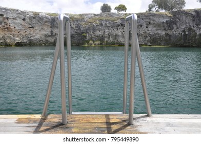 The top of a step of steps dropping down into a pool pool of water to allow access for swimmers