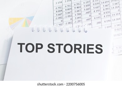 Top Stories Text Message On Notepad Background