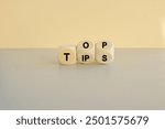 Top tips symbol. Turned wooden cubes with words 