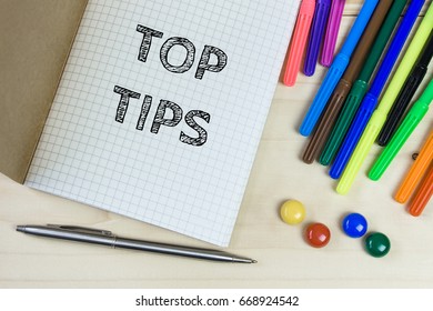 Top tips. Text message on white paper and office supplies. Business concept. View from above, Top view