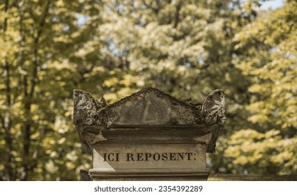 Top of a tomb with the Latin inscription 'here they rest'. Death, desolation in a cemetery. Remembrance of loved ones, silence and respect for the deceased.