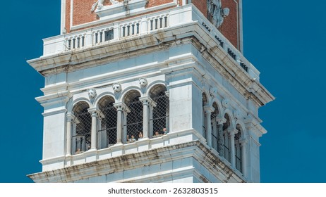Top of tower on the famous 16th century cathedral on San Marco square timelapse. Its roof has an angel-topped spire belfry offering amazing views over Venice. People watching from viewpoint