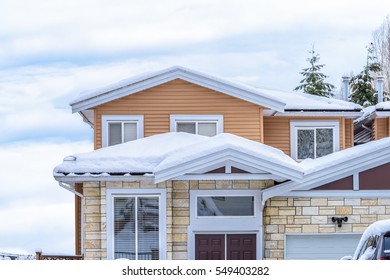 The Top Of A Typical American Home In Winter. Snow Covered Roof And Nice Window.