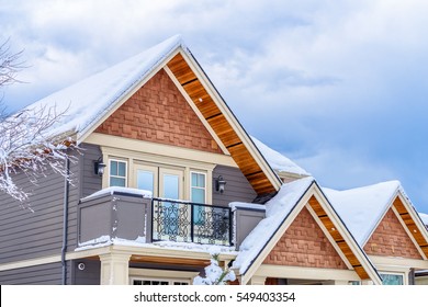 The Top Of A Typical American Home In Winter. Snow Covered Roof And Nice Window.