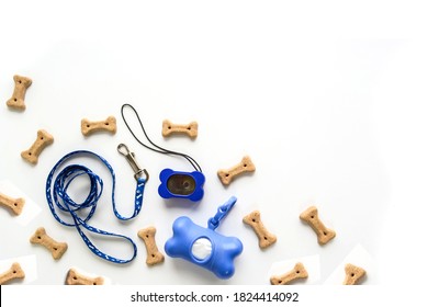Top Veiw On Pet Equipment. Leash, Clicker, Cookies, Box For Garbage Bags. Pet Shop Concept Or Dog Training Center, With Copy Space, Isolated On White Background