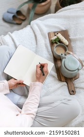 Top Vertical View Of Student Woman Sit On Bed In Boho Chic Bedroom, Make Education Notes In Journal, Study At Home. Inspiration Concept. Female Hands Hold Pen And Personal Diary With Copy Space Pages