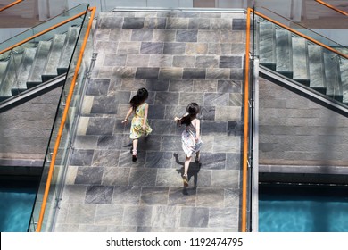 Top View Of 2 Kids Girls Running On The Bridge.