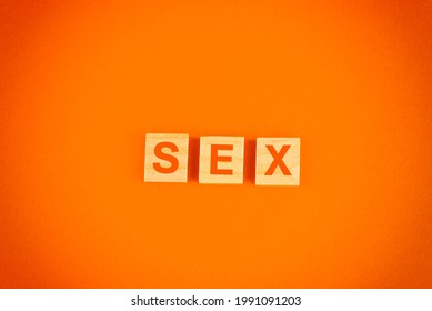 A Top View Of 3 Wood Blocks With The Word On An Orange Background