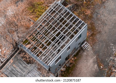 Top View Of An Abandoned Building With An Unfinished Repair Of Wooden Roof.