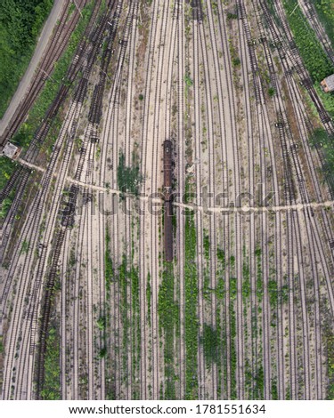 top view of an abandoned train in the middle of an old trainyard