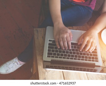 Top View (above) Of Beautiful Young Hipster Woman's Hands Busy Working On Her Laptop Sitting At Wooden Table In A Coffee Shop - Retro Filter Effect And Vintage Color Style