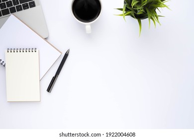 Top View Above Of White Office Desk Table With Keyboard, Notebook And Coffee Cup With Equipment Other Office Supplies. Business And Finance Concept. Workplace, Flat Lay With Blank Copy Space.