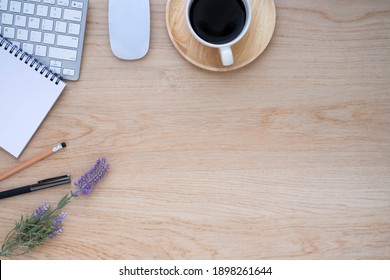 Top View Above Of Wood Office Desk Table With Keyboard, Coffee Cup And Notebook, Mouse Computer With Equipment Office Supplies. Business And Finance Concept. Workplace, Flat Lay With Blank Copy Space.