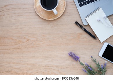 Top View Above Of Wooden Office Desk Table With Keyboard Of Laptop And Notebook With Equipment Other Office Supplies. Business And Finance Concept. Workplace, Flat Lay With Blank Copy Space.