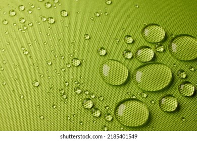 Top view abstract green textile with closeup transparent small water drops on laminated wet water repellent fabric in light room - Shutterstock ID 2185401549