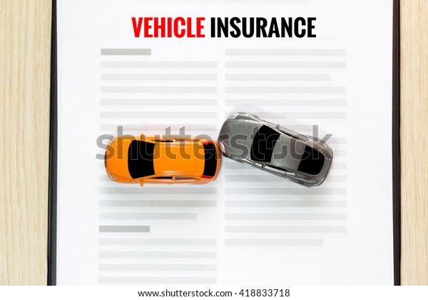 Top\
view of Accident toy car with toy vehicle\
insurance.