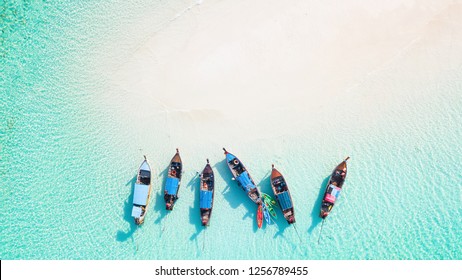 Top view or aerial view of Beautiful crystal clear water and white beach with long tail boats in summer of tropical island or Koh Lipe in Satun,Southern Thailand with copy space