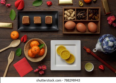 Top View Aerial Image Shot Of Arrangement Decoration Chinese New Year & Lunar New Year Holiday Background Concept.Flat Lay Fresh Orange With Food & Drink On Modern Brown Wooden At Home Office Desk.