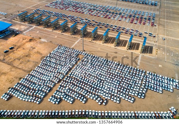 Top view aerial of International\
 container port SPCT, with new cars lined up in the port for import\
and export around the world. Nha Be, Ho Chi Minh,\
Vietnam