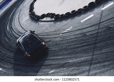 Top View Aerial Photo From Flying Drone Of A Professional Driver Drifting Car On Asphalt Track.