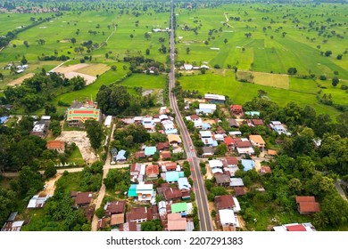 Top View Aerial Photo From Flying Drone Over Beautiful Green Rice Field And Village From Above.The Road Passes Through Small Villages And Leads To Green Rice Fields.