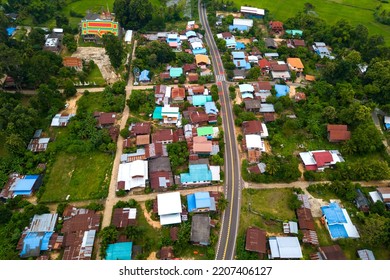 Top View Aerial Photo From Flying Drone Over Beautiful Green Rice Field And Village From Above.The Road Passes Through Small Villages And Leads To Green Rice Fields.