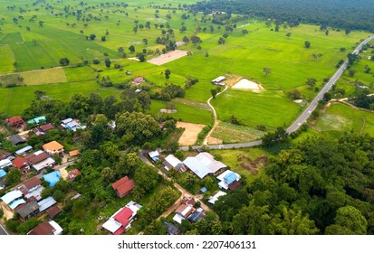 Top View Aerial Photo From Flying Drone Over Beautiful Green Rice Field And Village From Above.The Road Passes Through Small Villages And Leads To Green Rice Fields.