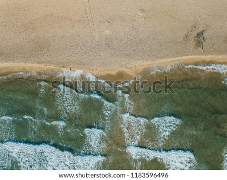 Similar – Luftpanorama-Drohne Blick auf die Meereswellen, die am felsigen Strand erdrücken.