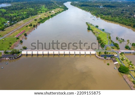 Top view Aerial photo from flying drone over concrete small dam or medium sized dam blocks the Mun River,HUANA DAM Sisaket province,Thailand,ASIA.