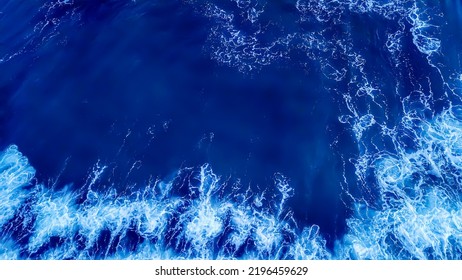 Top View Aerial Photography White Sea Foam Against The Background Of The Blue Sea Or Ocean. Background, Screensaver