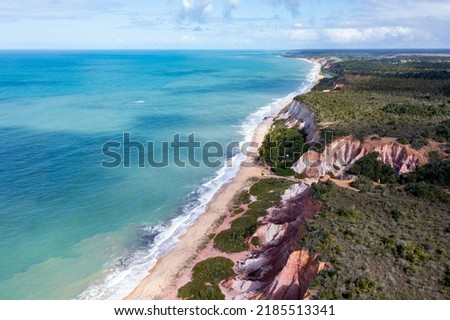 Top view, Aerial view of Pitinga beach in Arraial Da Ajuda, Porto Seguro, Bahia. Landscape of the cliffs with the waters of the Brazilian Northeast Sea.