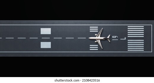 Top view of airplane model on the runway, flat lay design.