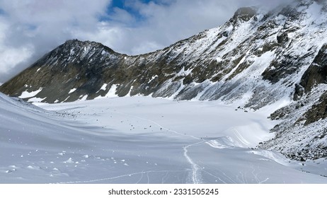 Top view of the Akkem glacier and the snow-covered Delaunay pass. Climbing Mount Belukha. Altai Mountains. Beautiful mountain landscape. Amazing natural background.