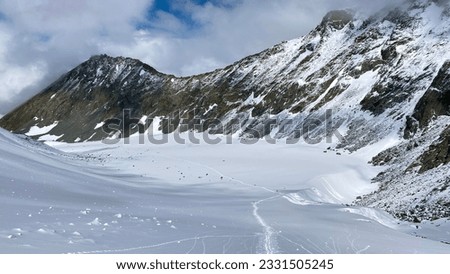 Top view of the Akkem glacier and the snow-covered Delaunay pass. Climbing Mount Belukha. Altai Mountains. Beautiful mountain landscape. Amazing natural background.