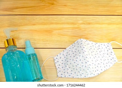 Top view of Alcohol gel and spray with DIY fabric cotton face mask on wood table. Copy space. Protection for Covid-19, Corona virus. Healthcare concept. - Shutterstock ID 1716244462