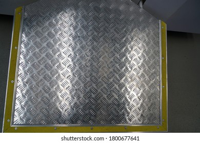 A Top View Of An Aluminum Tread Plate In A Bus Under The Lights