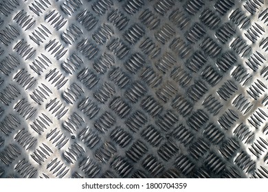 A Top View Of An Aluminum Tread Plate In A Bus Under The Lights