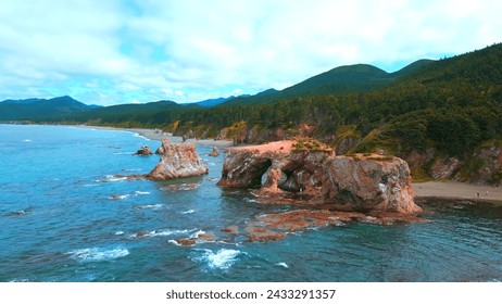 Top view of amazing cliffs of sea coast. Clip. Rocks with erosion of sea waves create amazing stone arches. Beautiful rocky arches on seashore - Powered by Shutterstock