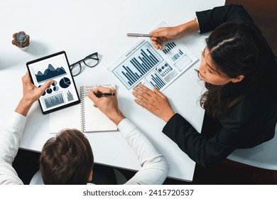 Top view Analyst team uses BI Fintech display tablet to analyze financial data. Business people analyze BI software technology dashboard power for insight power into marketing planning. Prudent - Powered by Shutterstock