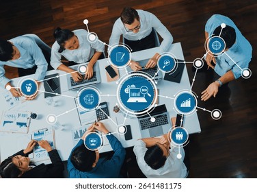 Top view analyst team utilizing BI Fintech to analyze financial data at table in meeting room. Analytic BI dashboard power on paper for business insight and strategic marketing planning. Prudent Amity