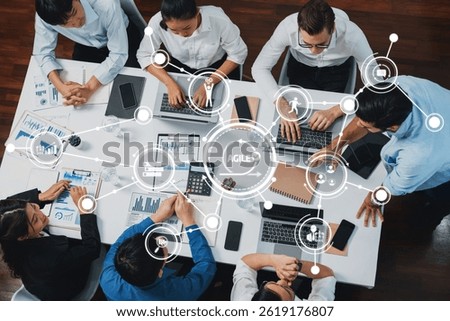 Top view analyst team utilizing BI Fintech to analyze financial data at table in meeting room. Analytic BI dashboard power on paper for business insight and strategic marketing planning. Prudent Amity