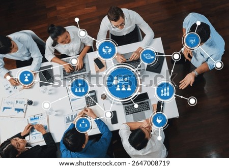 Top view analyst team utilizing BI Fintech to analyze financial data at table in meeting room. Analytic BI dashboard power on paper for business insight and strategic marketing planning. Prudent Amity