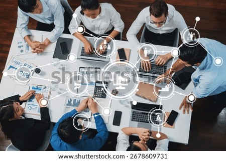 Top view analyst team utilizing BI Fintech to analyze financial data at table in meeting room. Analytic BI dashboard power on paper for business insight and strategic marketing planning. Prudent Amity